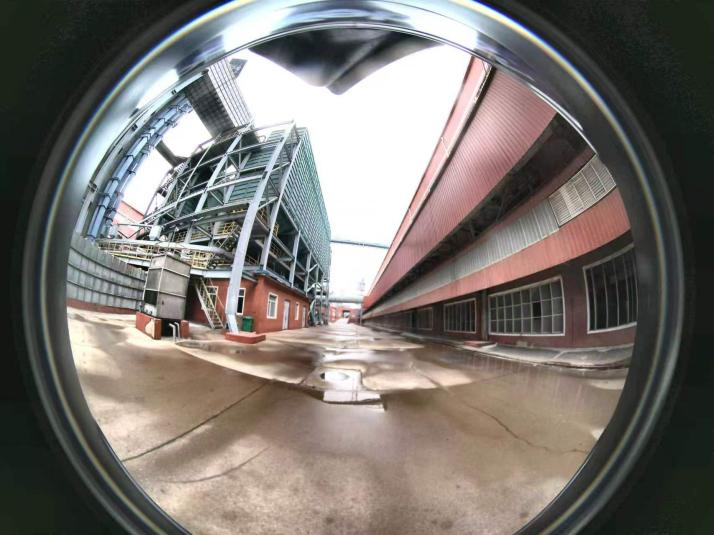 Panoramic capture of the industrial courtyard and overhead piping