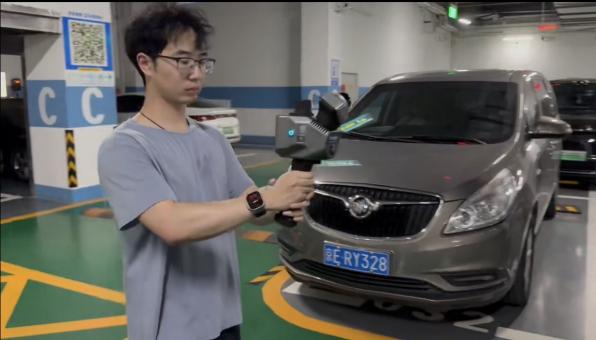 Operator scanning an underground garage with a handheld LiDAR scanner